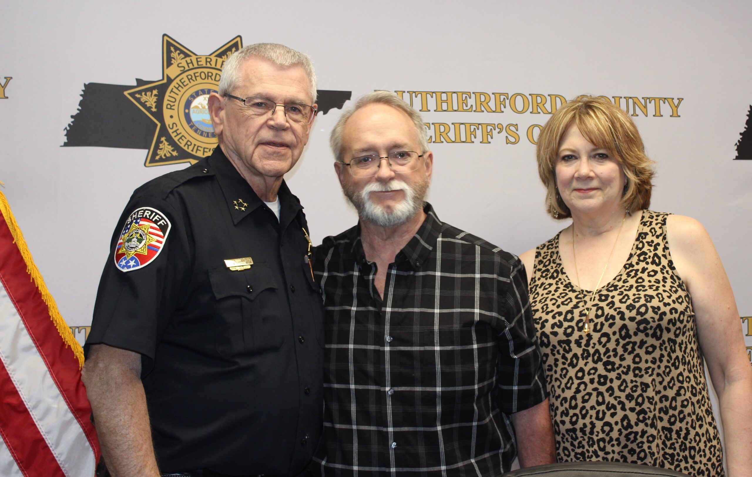 Sheriff Mike Fitzhugh congratulates Sgt. Dan Goodwin and his wife, Debbie, on his retirement after 30 years of service.