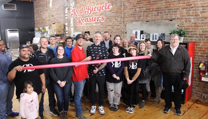 Ribbon Cutting for Red Bicycle on the Square