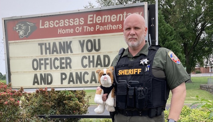 Lascassas SRO Chad Dodson holds Pancake the dog