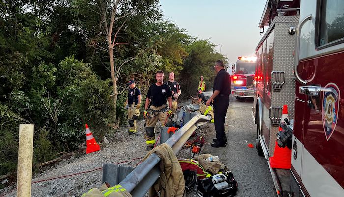 Driver trapped after semi plunges down steep embankment