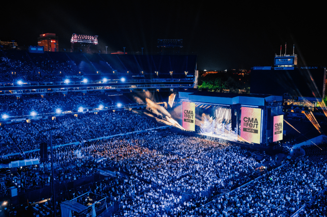 CMA Fest crowd at Nissan Stadium Nashville with stage lights