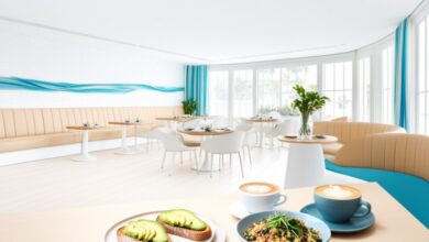 Bright, airy interior of Two Hands, an Australian-inspired all-day cafe in Nashville's Gulch, with avocado toast, a grain bowl and lattes on a wood table