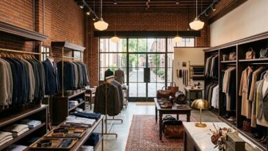 Interior of the Mashburn menswear and womenswear boutique in Nashville Germantown Neuhoff District, with tailored suits on racks inside a restored brick building