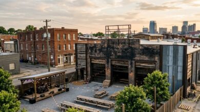 A large barbecue hall with an outdoor beer garden and stage in a historic brick neighborhood at golden hour