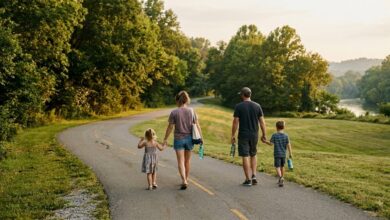 A family with two young children walking a paved greenway path beside a river on a summer evening in Middle Tennessee (illustrative)