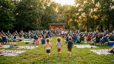 Families on blankets and camp chairs at a free outdoor concert on a park lawn at golden hour (illustrative)