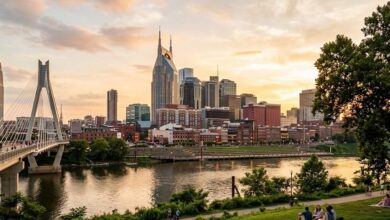 The Nashville skyline and pedestrian bridge seen across the Cumberland River at golden hour (illustrative)
