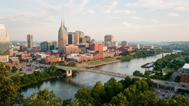 Downtown Nashville skyline above the Cumberland River on a summer morning (illustrative)