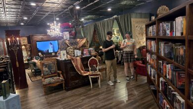 Bookshelves, chandeliers and antique furniture inside The Raven Book Lounge in Brentwood