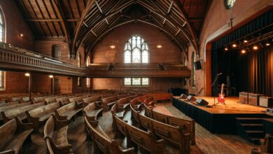 Historic Nashville auditorium interior with oak pews and a lit wooden stage before a blues concert (illustrative)