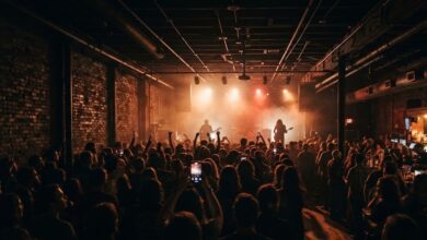 A packed East Nashville rock club crowd facing a backlit stage (illustrative)