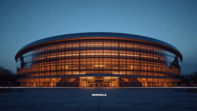 A modern enclosed domed stadium lit from within at dusk above an empty plaza (illustrative)