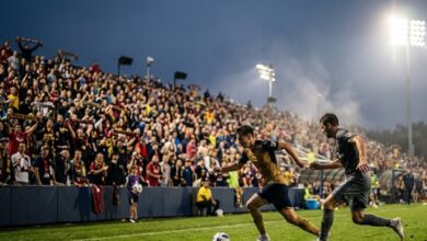 Players contest the ball in a professional soccer match under stadium floodlights (illustrative)